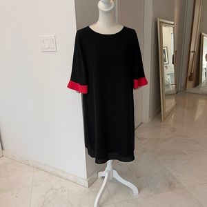 Black dress with red sleeves.